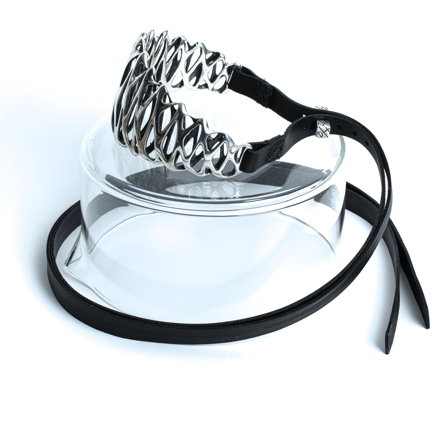 Side view of a tall solid sterling silver neck cuff with contrast-oxidized recessed details. Long black leather straps feature 5 punch holes to secure the collar to the neck for a custom fit.
