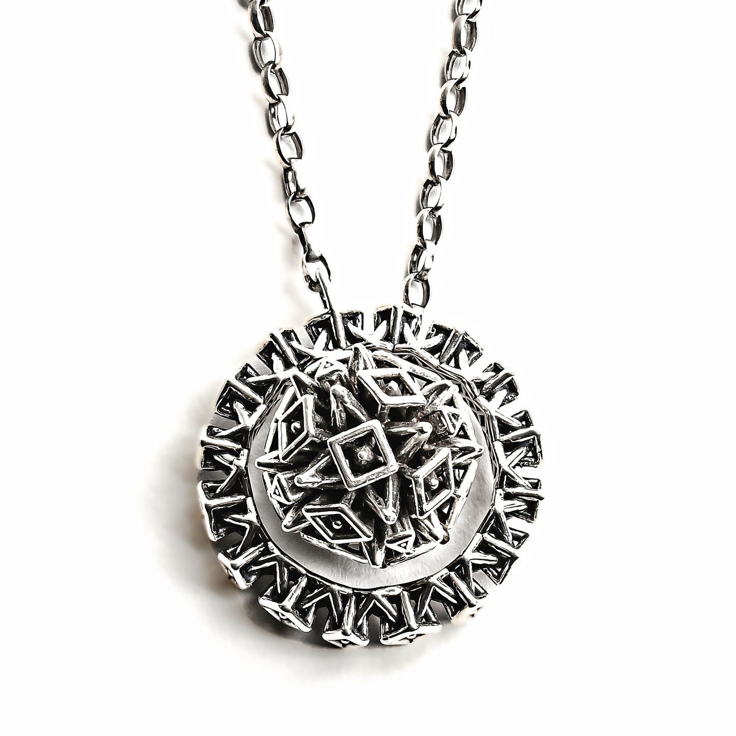 This solid sterling silver lariat may be worn many different ways making it multiple necklaces in one. In this image it's styled as a medallion necklace with the sphere resting inside the ring, which radiates like a halo around it.