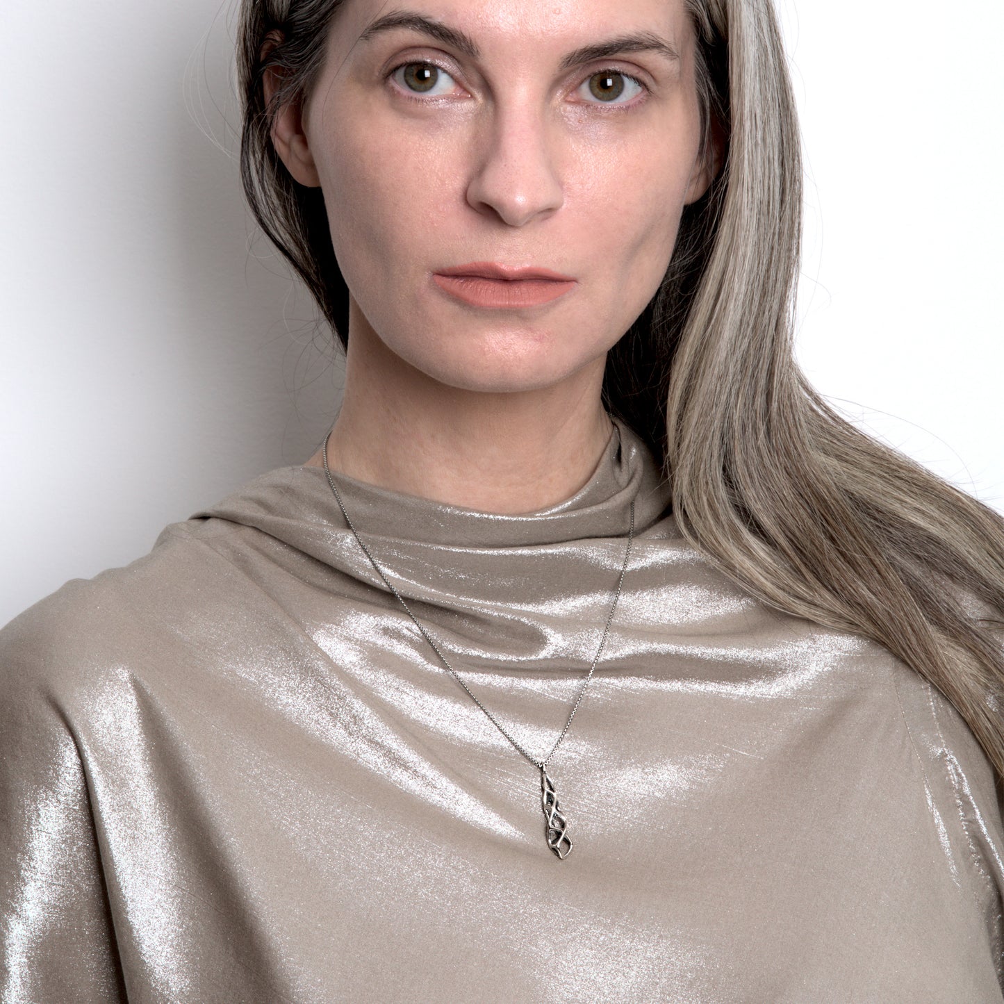 Our contrast oxidized sterling silver stalactite lattice pendant necklace is styled with a metallic designer top.