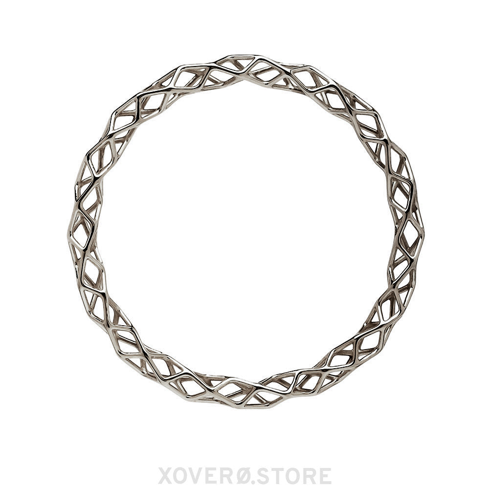 A sterling silver bangle bracelet with a highly polished dimensional lattice geometry. The delicate form is packed with light scattering detail.