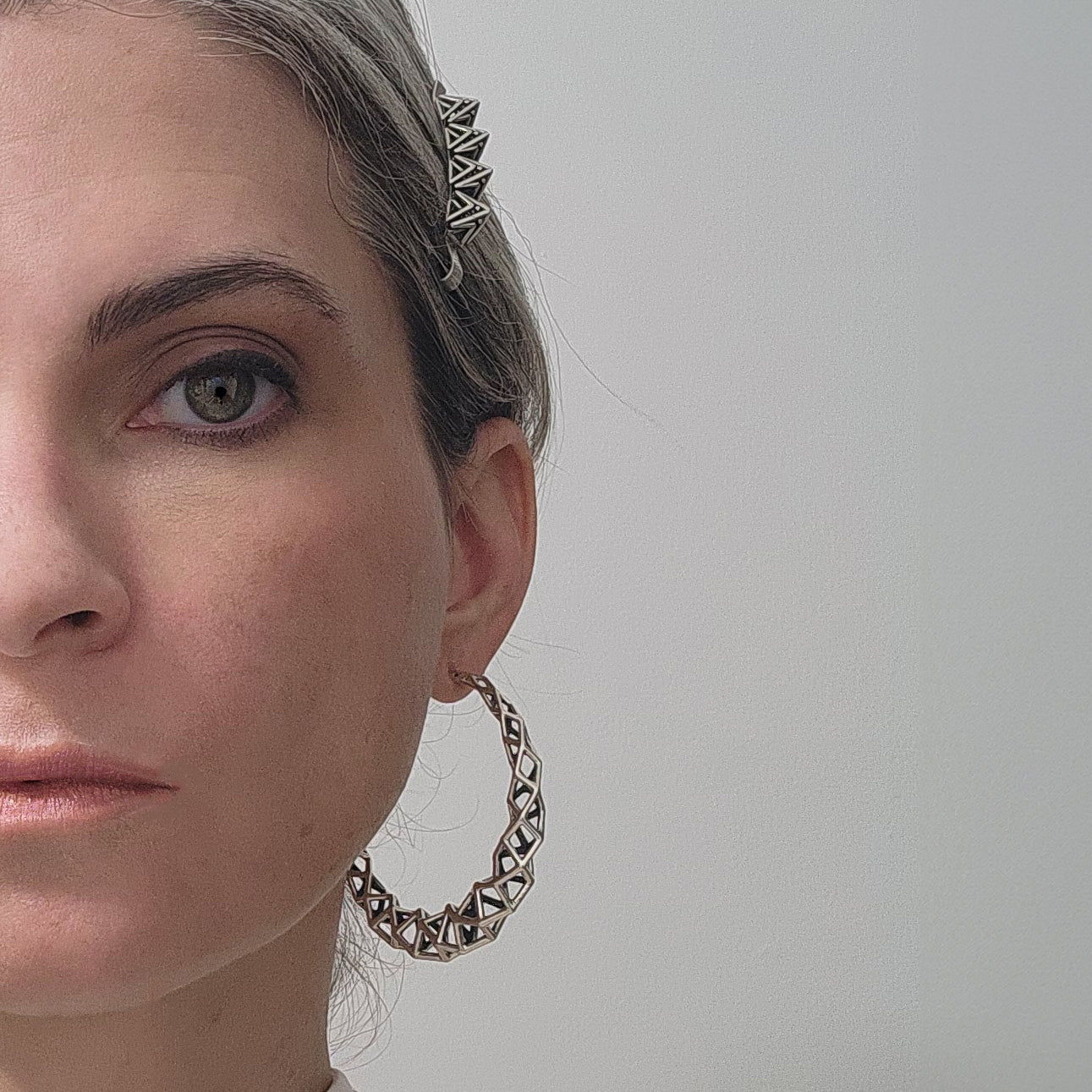 Sterling silver spike covered heirloom bobby pin crowns the head with an edgy accessory. Worn here with large geometric hoop earrings.