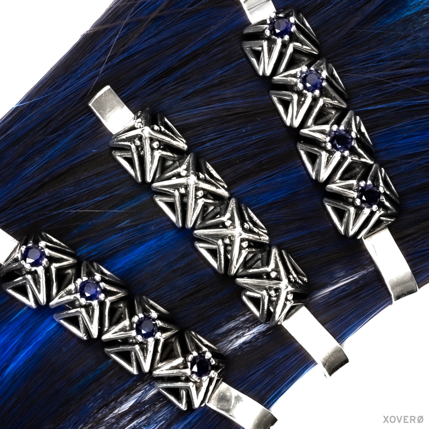 Xover0's Art Deco- inspired solid sterling silver and sapphire heirloom bobby pins clipped to a strand of blue hair.