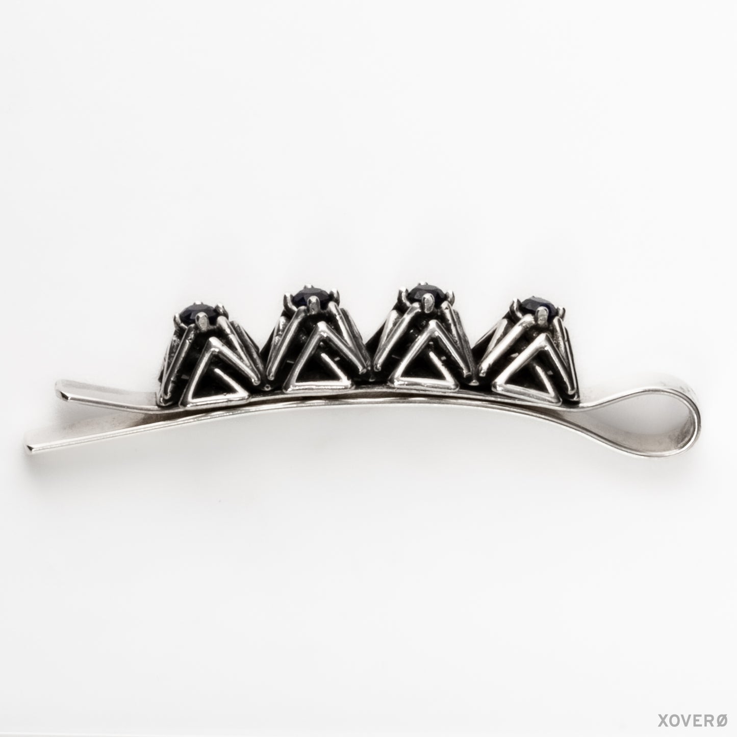 Xover0's solid sterling silver geometric lattice bobby pin with hand-set sapphires viewed from the side showing the design's proportions in clear detail.