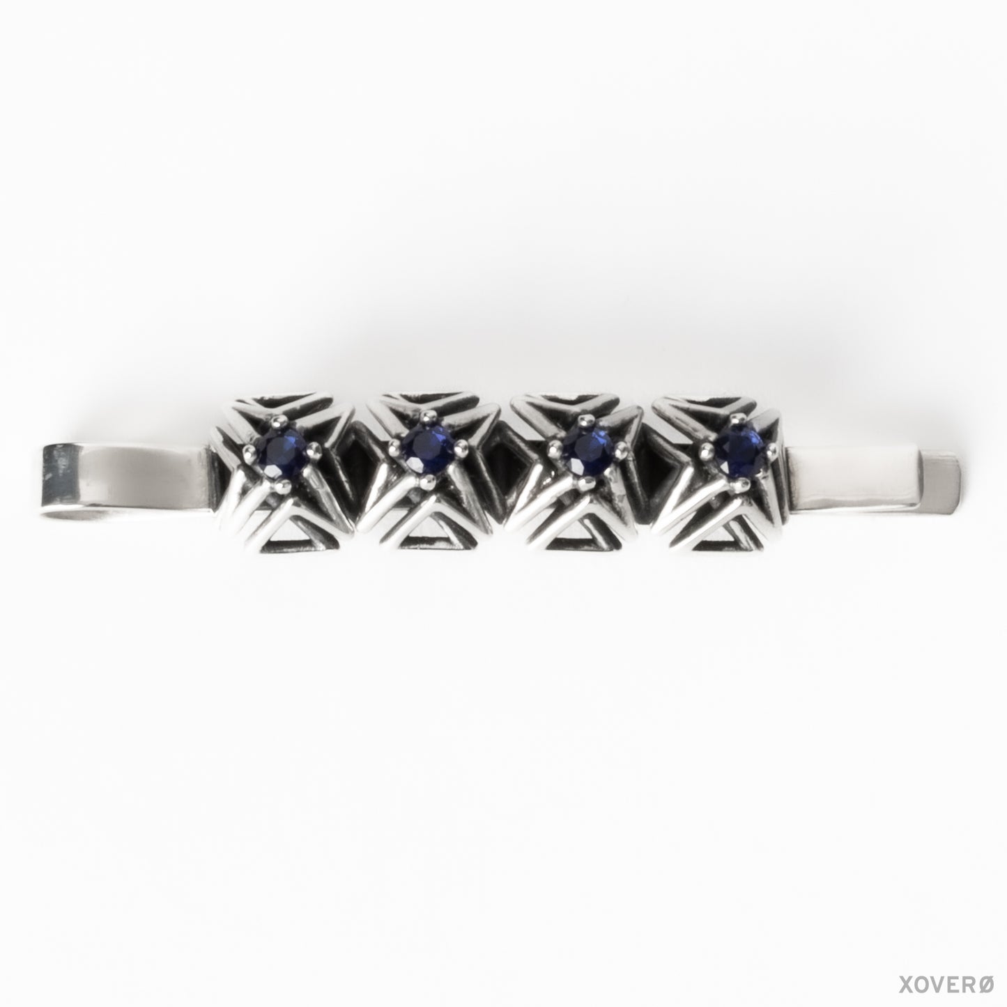 Architectural latticework bobby pin crafted from solid sterling silver with four hand-set blue sapphires.