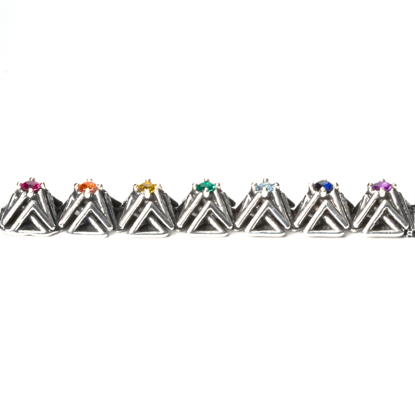 Side view of the solid .925 bar pendant with rainbow gemstones. This photo shows the dimension of the complex stud settings. Each pyramid spike measures about 1x1x1 cm.