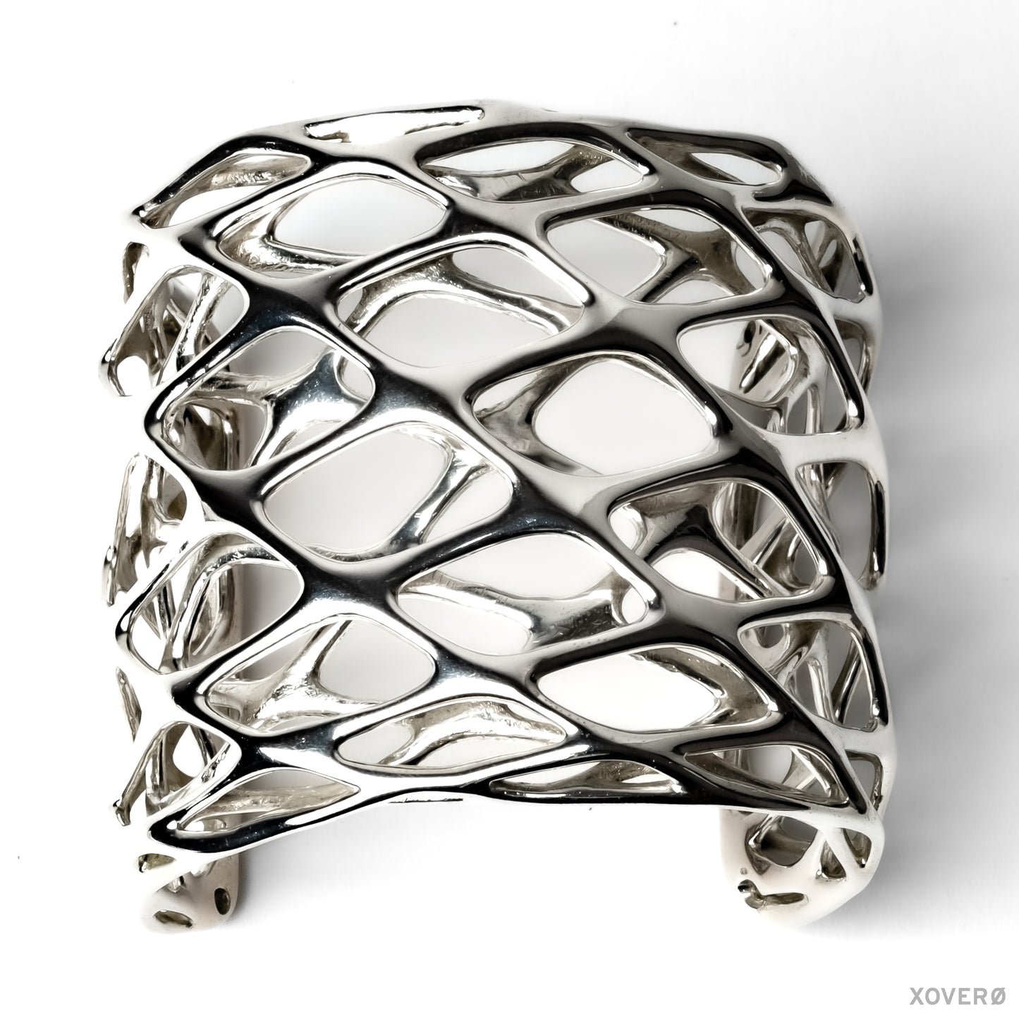 Tall dimensional sterling silver cuff bracelet with fluid angular lattice design.