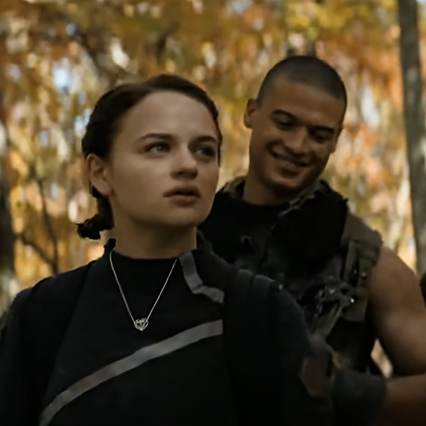 The Geoheart Pendant Necklace is worn by Joey King as Tally Youngblood in Netflix's Uglies. Seen here walking through the woods with a new friend, the cool silver necklace contrasts beautifully with the warm autumn leaves surrounding them.