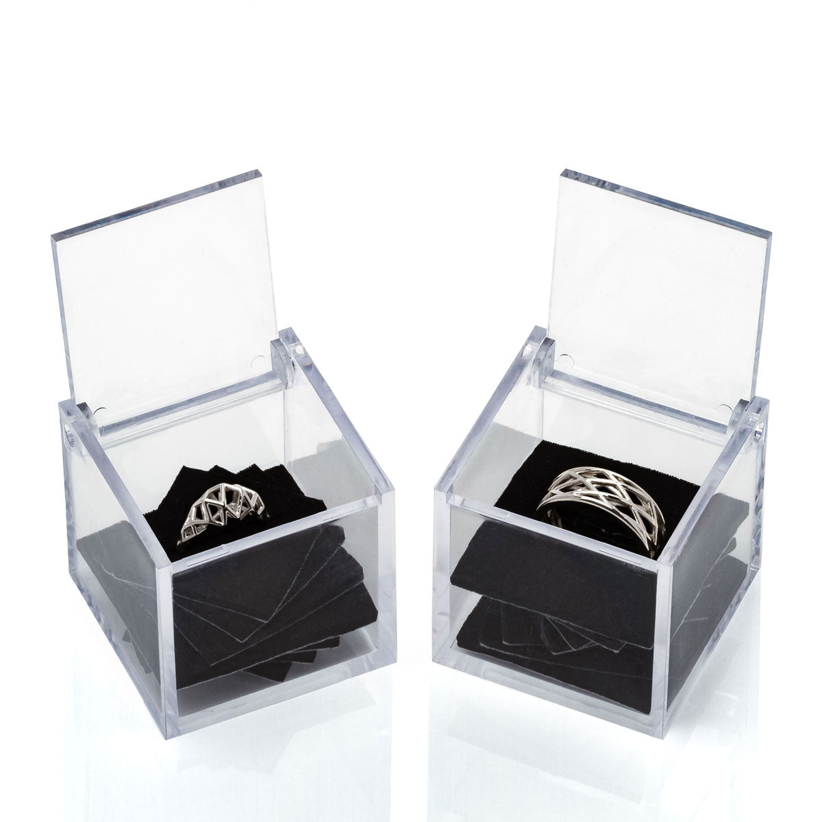 Wedding ring set sharing architectural geometry in different silhouettes. One is a modern interpretation of traditional Art Deco engagement rings. The other is a masculine or unisex band of latticework.