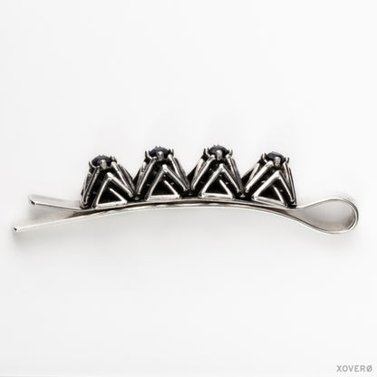 Xover0's solid sterling silver geometric lattice bobby pin with hand-set sapphires viewed from the side showing the design's proportions in clear detail. 