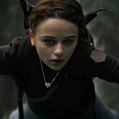 Joey King as Tally Youngblood in Netflix's Uglies wearing the Geoheart Pendant Necklace, crafted in durable solid sterling silver. The pendant is seen here in an action scene where Tally survives a fall, with the necklace still intact and visible around her neck.