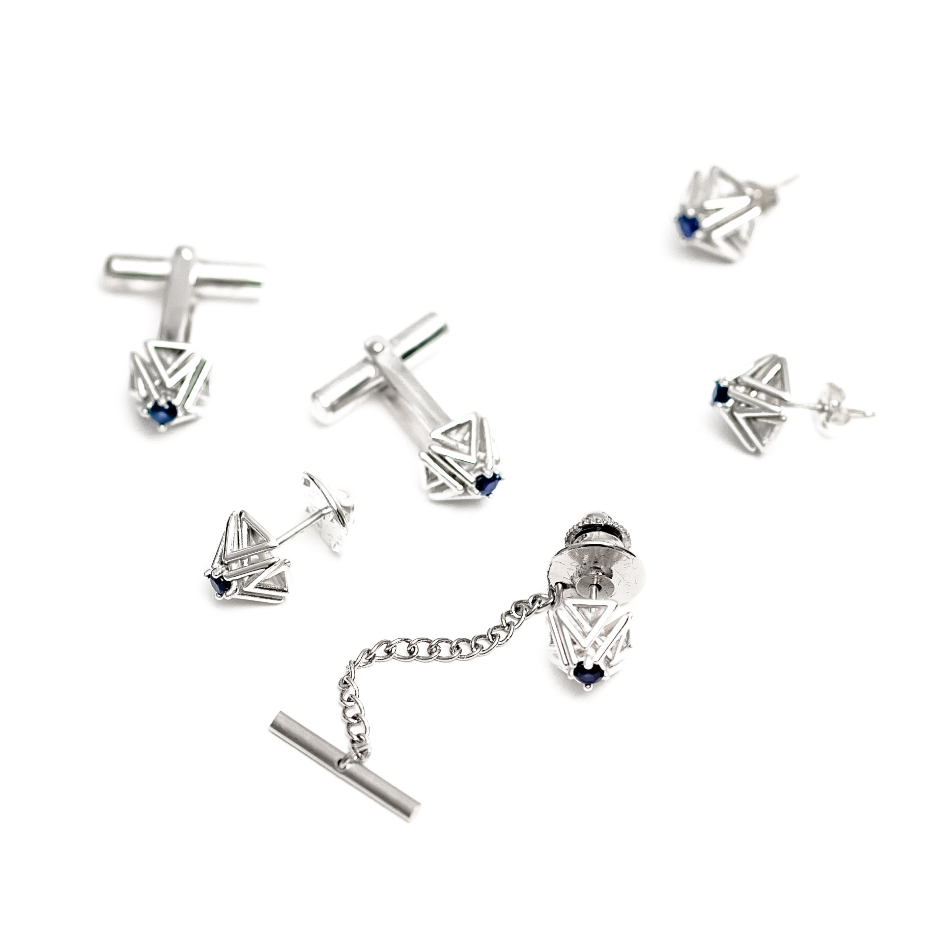 This pair of sapphire and solid sterling silver cuff links is part of a collection that includes a matching tie tack, and earrings, all shown here on a white background. 