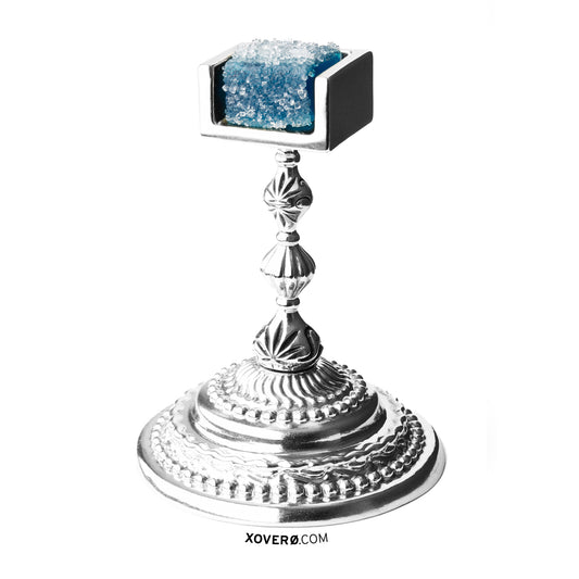 Solid sterling silver chalice crafted specifically for presenting a cannabis edible to an esteemed dinner guest, shown with a blue weed gummy. 