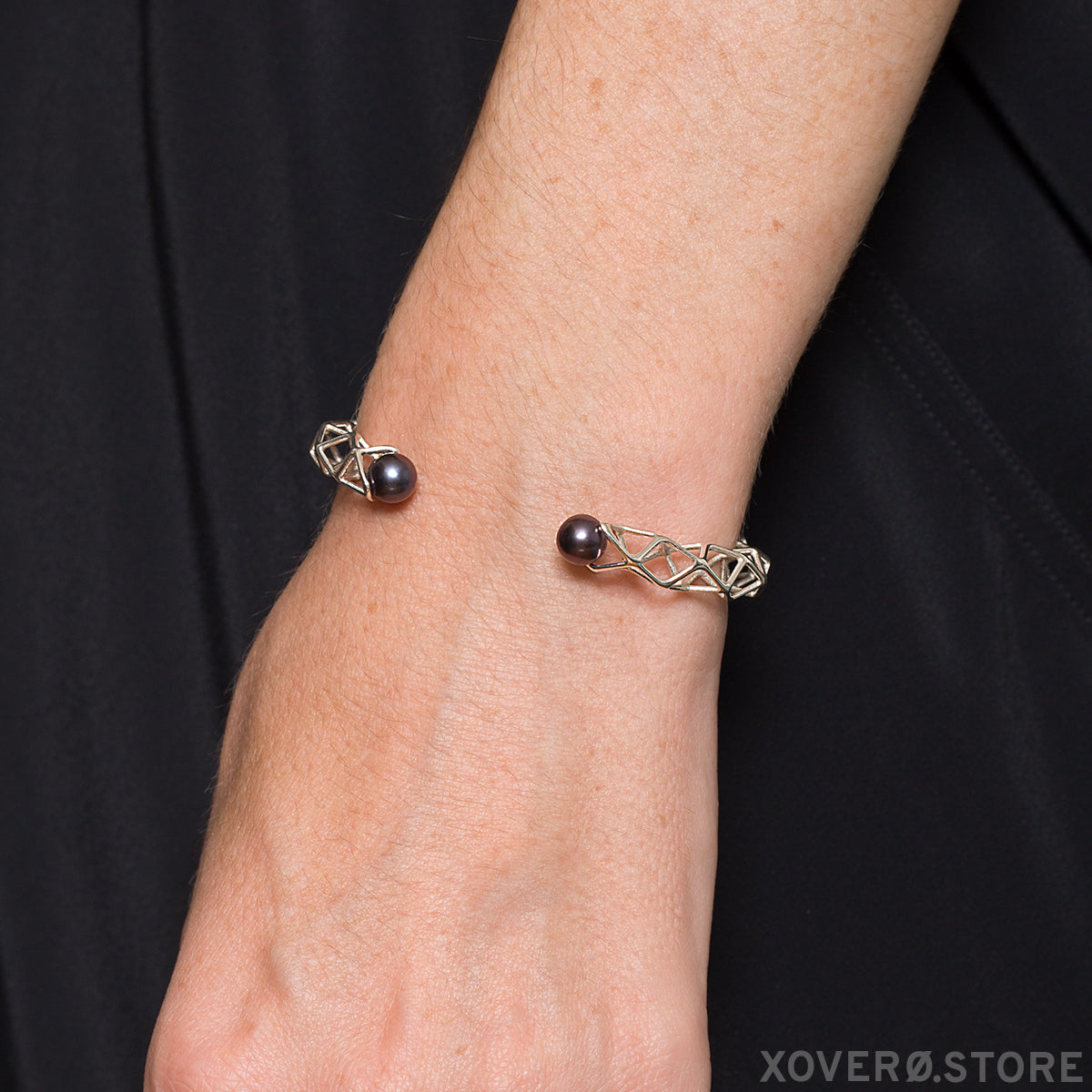 The delicate nature of our solid sterling and black pearl cuff bracelet is shown on the wrist. 